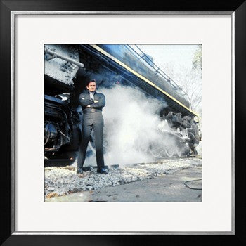 Johnny Cash Wearing Black Clothing and Standing in Front of a Locomotive