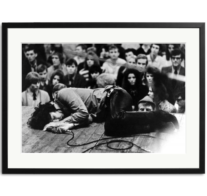 Jim Morrison lies on stage during a concert